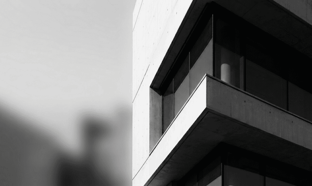 Modern office building with sharp architectural lines in black and white.